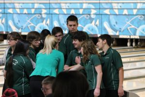 Bowling coach Alexis Ijams pep-talks the bowlers before they start their meet