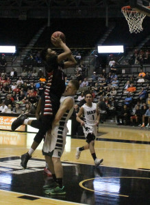 Blocking a shot, senior Josh Mark plays against Shawnee Mission North in the state basketball game at Koch Arena.
