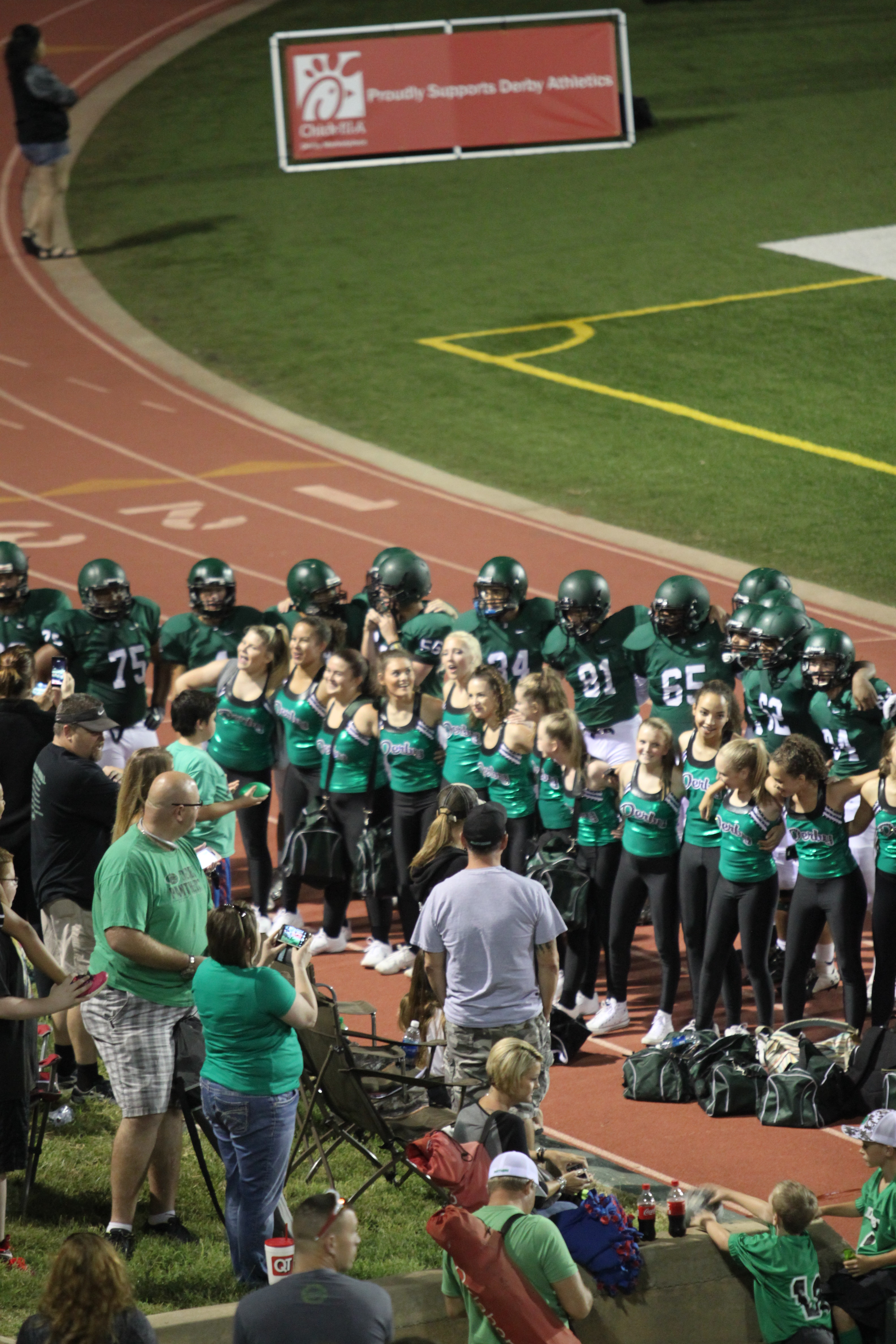 The Derby Football Team and Pantherettes get together after a stunning victory to sing the Derby Alma Mater.