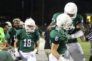 Senior Peerlus Walker jumps on senior Tommy carter in celebration. 