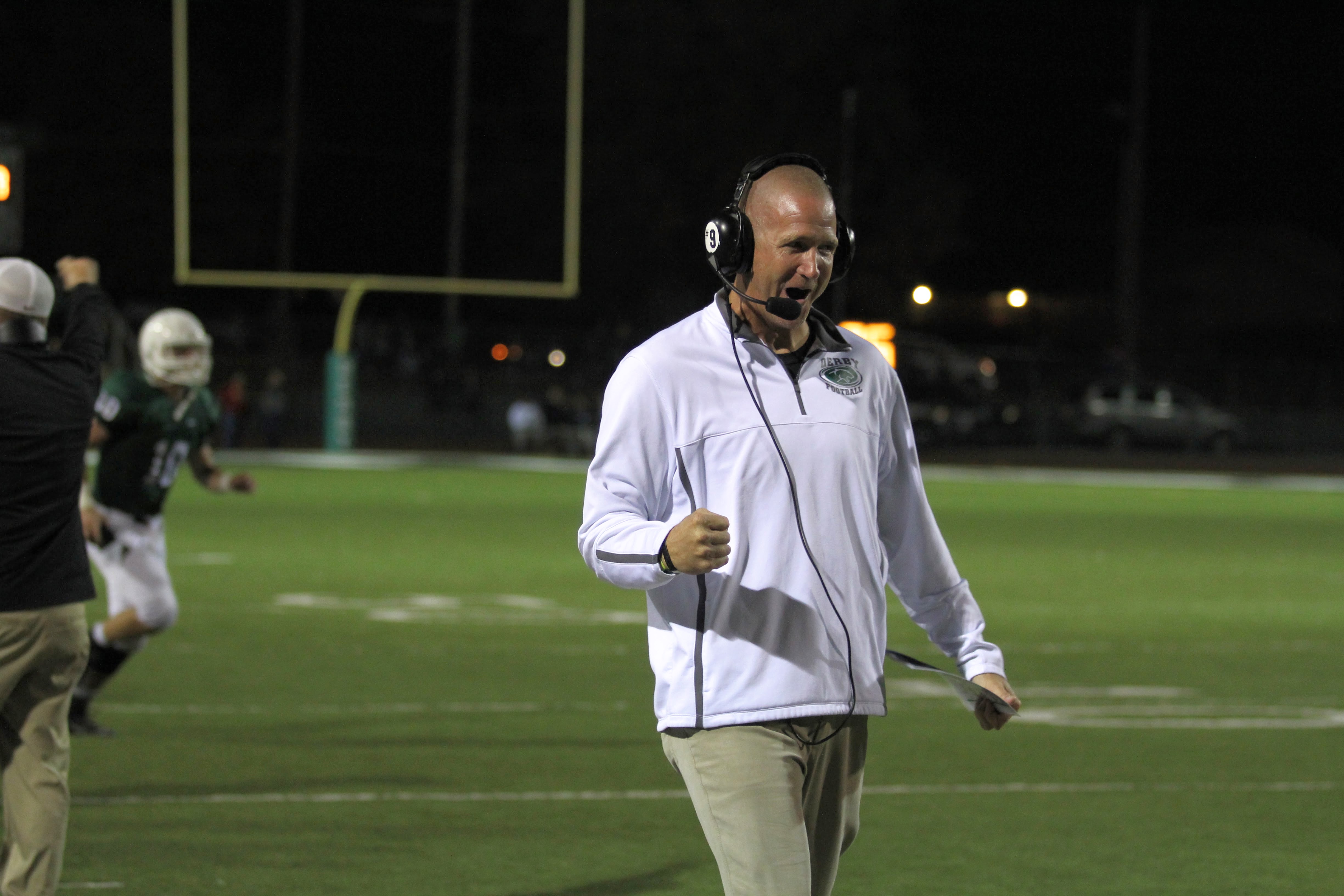 Coach Clark cheers from the sideline