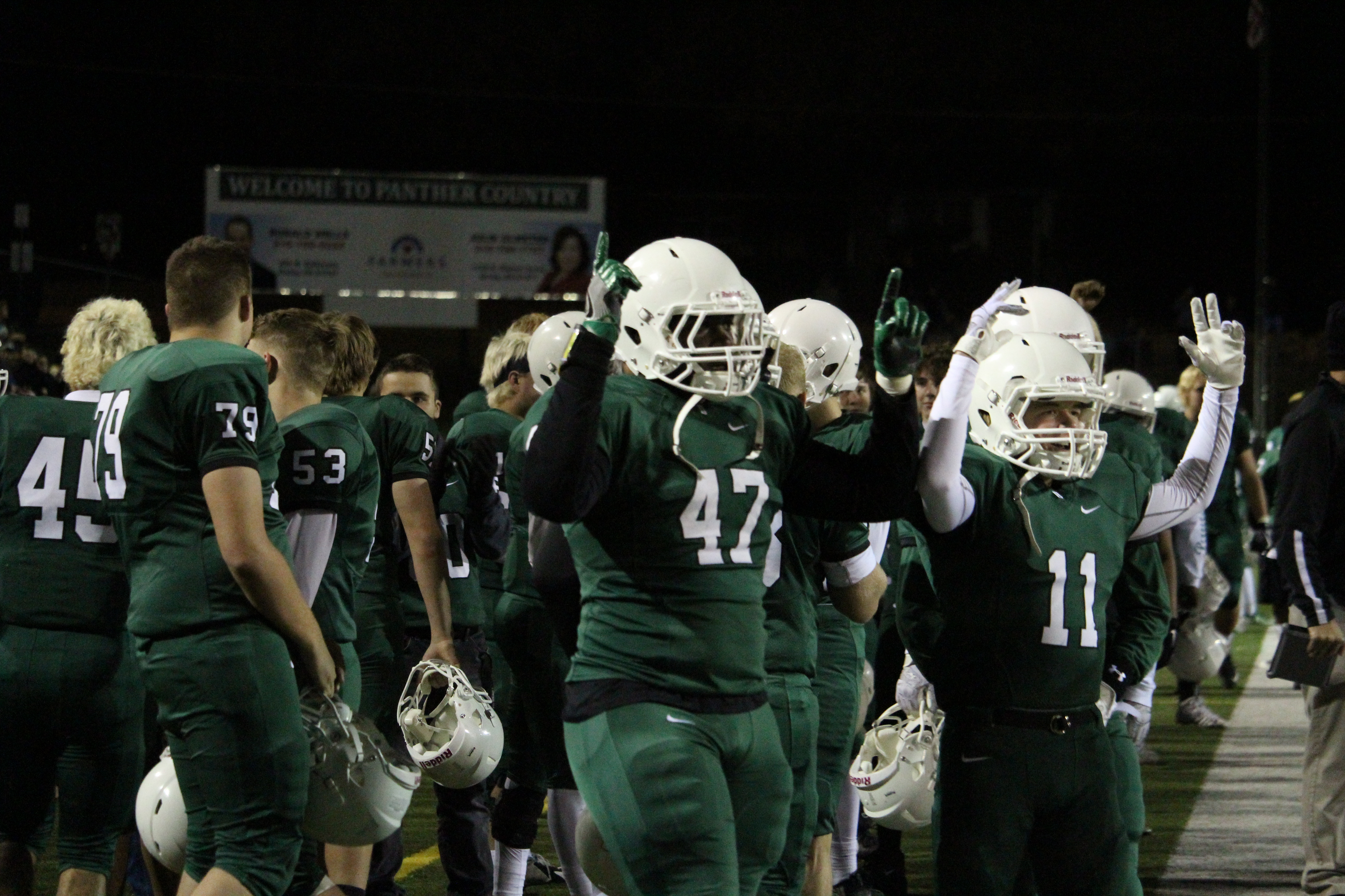 Seniors Peerlus Walker and James Werbin lift there arms in celebration