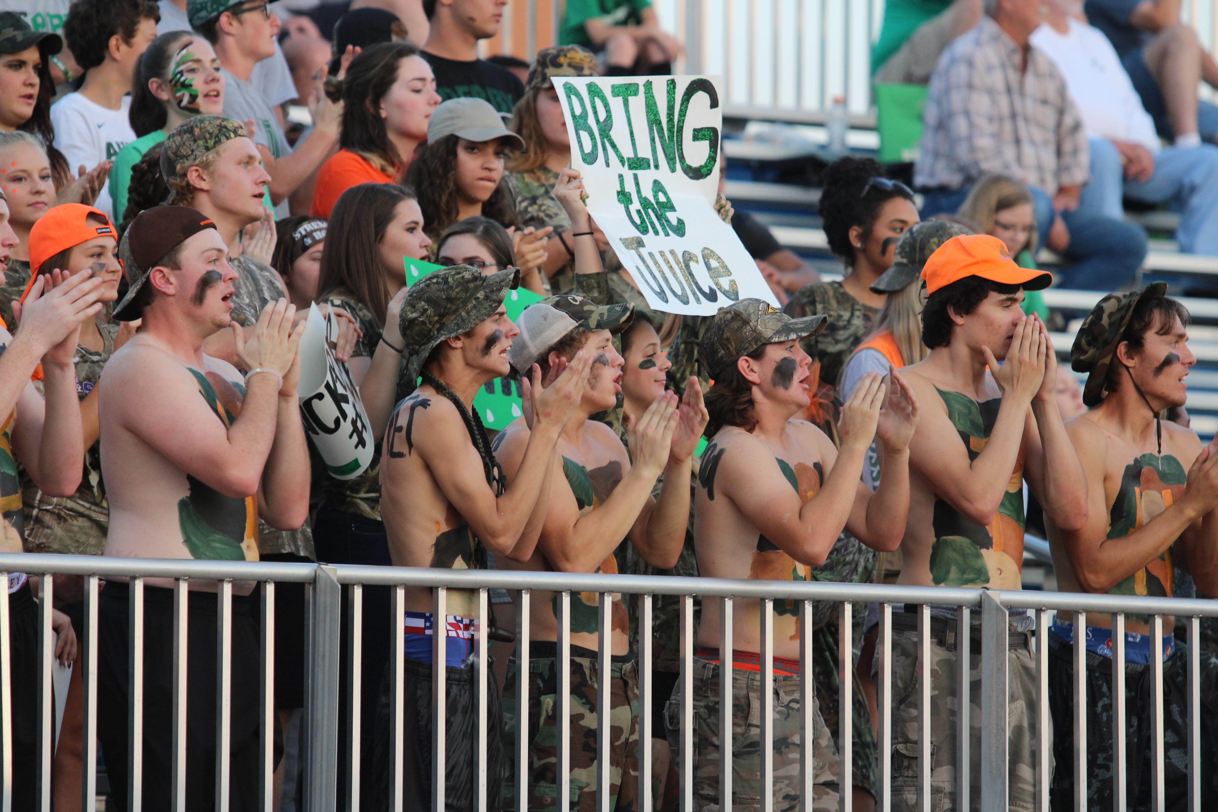 Derby students cheers from the stands with a sign that read "Bring the Juice"